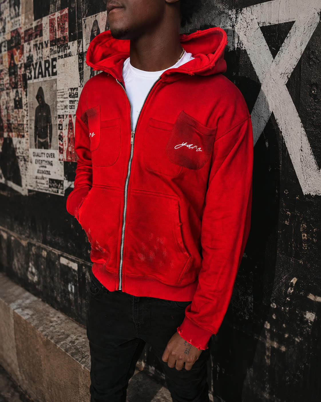 The red Double Pocket YARE Jacket styled on an urban street